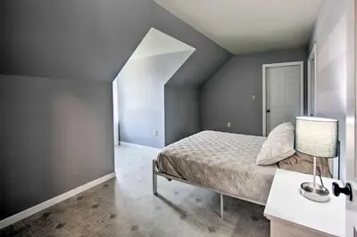 a bedroom with a bed and a lamp on a table at Peaceful Bird in Hand Home with Farmland Views! in Bird in Hand