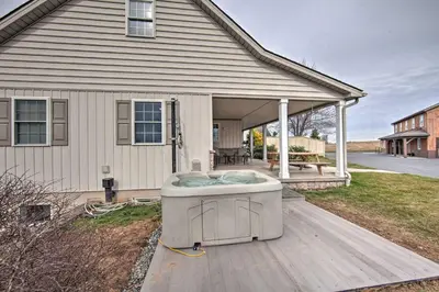 a hot tub sitting on a deck in front of a house at Peaceful Bird in Hand Home with Farmland Views! in Bird in Hand