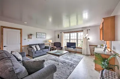 a living room with a couch and a table at Peaceful Bird in Hand Home with Farmland Views! in Bird in Hand
