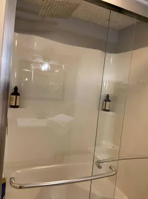 a shower with a glass door in a bathroom at Aquatopia Waterpark-Pool-Tennis-Paintball- ZipLine 127 in Tannersville
