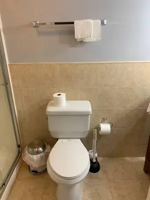 a bathroom with a toilet with a roll of toilet paper at Aquatopia Waterpark-Pool-Tennis-Paintball- ZipLine 127 in Tannersville