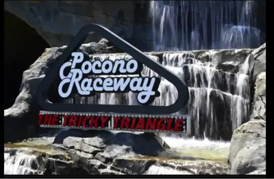 a sign in front of a waterfall at Aquatopia Waterpark-Pool-Tennis-Paintball- ZipLine 127 in Tannersville