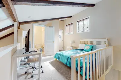 a bedroom with a bed and a desk with a computer at Camelback 69 in Tannersville