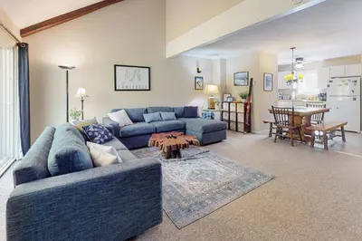 a living room with a blue couch and a table at Camelback 69 in Tannersville