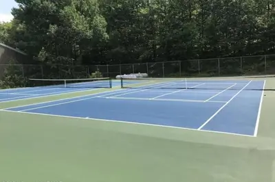 a tennis court with two tennis rackets on it at Camelback 69 in Tannersville