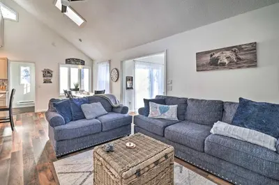 a living room with two couches and a table at Hot Tub, Fire Pit and Game Room Tobyhanna Home! in Tobyhanna