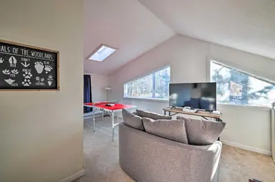 a living room with a couch and a tv and a table at Hot Tub, Fire Pit and Game Room Tobyhanna Home! in Tobyhanna