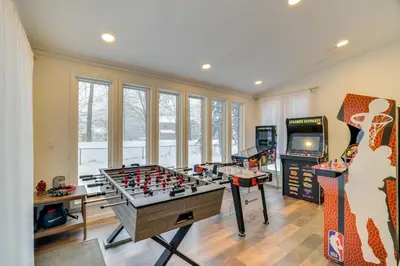 a game room with a foos ball and a video game at Hot Tub, Fire Pit and Game Room Tobyhanna Home! in Tobyhanna