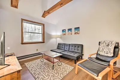 a living room with a couch and a table at 4 Mi to Tobyhanna State Park Home with Fire Pit in Tobyhanna