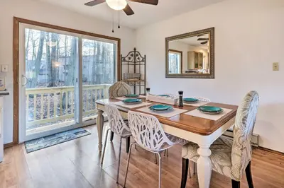 a dining room with a table and chairs and a mirror at 4 Mi to Tobyhanna State Park Home with Fire Pit in Tobyhanna