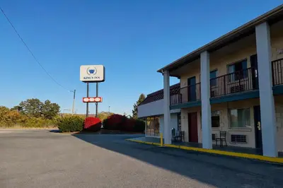 a hotel with a clock tower next to a building at King's Inn Motel in Reading