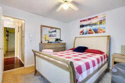 a bedroom with a bed with a checkered blanket at Zen Den - Pocono LakeFront with Hot Tub ! in Pocono Summit