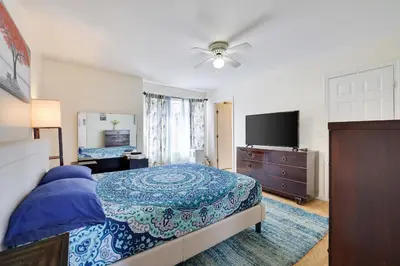a bedroom with a bed and a flat screen tv at Zen Den - Pocono LakeFront with Hot Tub ! in Pocono Summit