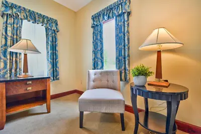 a home office with a desk and a chair and a table at Tom Quick Inn in Milford