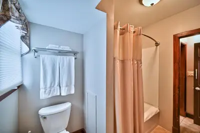 a bathroom with a toilet and a shower at Tom Quick Inn in Milford