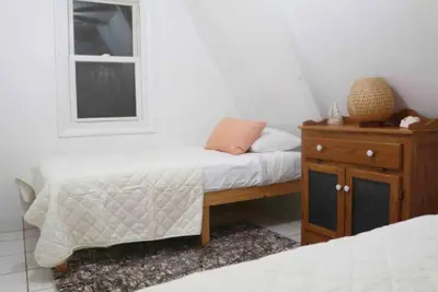a small bedroom with a bed and a window at Escape in our Rain-Forest A-Frame Retreat with Hot Tub at The Kairos Cabin in Harveys Lake