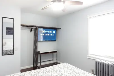 a bedroom with a bed and a ceiling fan at Best Home To Visit NYC+Hot Tub+EWR Airport+Free Parking in Hillside