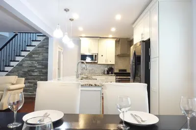 a kitchen and dining room with a table and chairs at Best Home To Visit NYC+Hot Tub+EWR Airport+Free Parking in Hillside