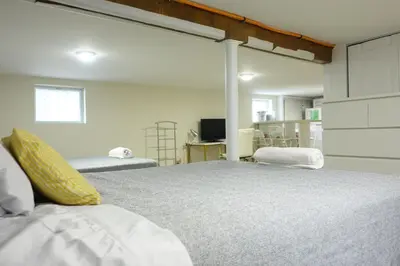 a bedroom with two beds and a television at Best EWR Airport Studio-Hot Tub-Free Parking in Hillside