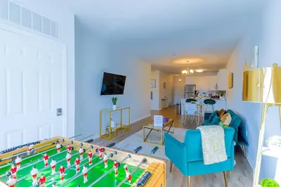 a living room with a pool table in the middle at Book Cozy King Bed Now 25 Percent OFF Spring Special! in Carteret