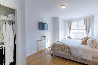 a white bedroom with a bed and a window at Book Cozy King Bed Now 25 Percent OFF Spring Special! in Carteret