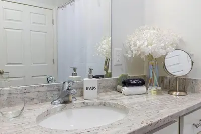 a bathroom counter with a sink and a mirror at Book Cozy King Bed Now 25 Percent OFF Spring Special! in Carteret