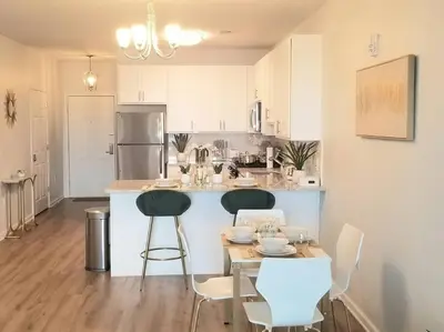 a kitchen with a table and two chairs and a counter at Book Cozy King Bed Now 25 Percent OFF Spring Special! in Carteret