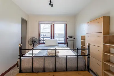a bedroom with a bed and a window at 1 Bus Stop To NYC-Hot Tub-EWR Airport-Free Parking in Hillside