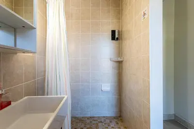 a bathroom with a tub and a shower at 1 Bus Stop To NYC-Hot Tub-EWR Airport-Free Parking in Hillside