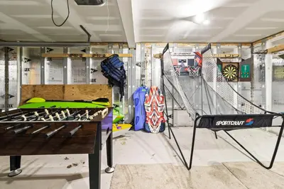 a room with a table and a room with snowboards at THE ONE Chalet in Albrightsville