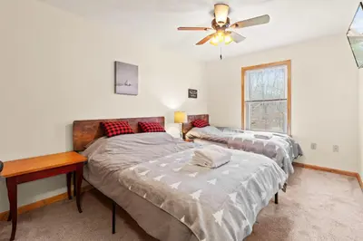 a bedroom with two beds and a ceiling fan at THE ONE Chalet in Albrightsville