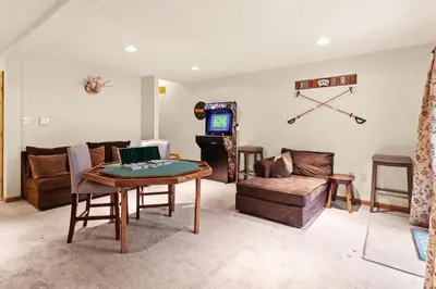 a living room with a table and a couch at THE ONE Chalet in Albrightsville