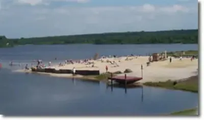 a body of water with a beach and people at THE ONE Chalet in Albrightsville