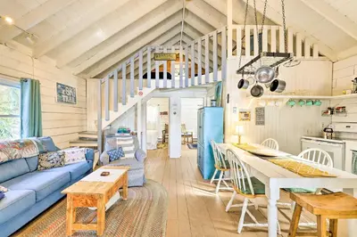 a living room with a blue couch and a table at Private Lake Access and Canoes Pennsylvania Cottage in Lakewood