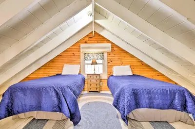two beds in a attic room with purple sheets at Private Lake Access and Canoes Pennsylvania Cottage in Lakewood