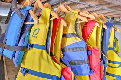 a group of yellow and blue firehoses hanging on a rack at Private Lake Access and Canoes Pennsylvania Cottage in Lakewood