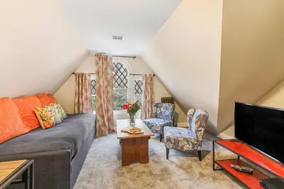 a living room with a couch and a tv at The South Mountain Inn in Wernersville
