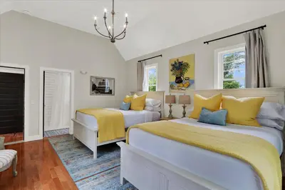 a bedroom with two beds with yellow and blue pillows at The South Mountain Inn in Wernersville
