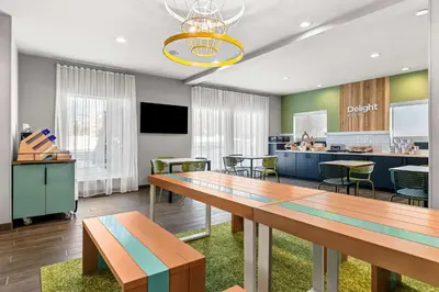 a dining room with a long table and chairs at Spark By Hilton Hershey Near The Park in Hershey