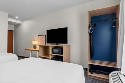 a hotel room with a bed and a flat screen tv at Spark By Hilton Hershey Near The Park in Hershey