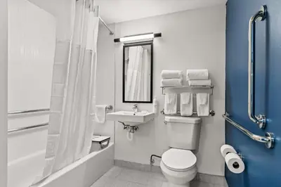 a bathroom with a white toilet and a sink at Spark By Hilton Hershey Near The Park in Hershey