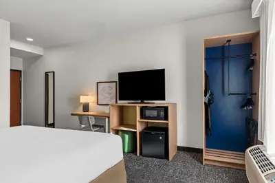 a hotel room with a bed and a flat screen tv at Spark By Hilton Hershey Near The Park in Hershey