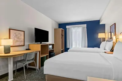 a hotel room with two beds and a desk at Spark By Hilton Hershey Near The Park in Hershey