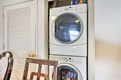 a washing machine and a dryer in a room at House with Pellet Smoker and Grill, 1 Mi to Lake! in Bellmawr