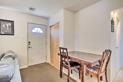 a dining room with a table and chairs and a couch at House with Pellet Smoker and Grill, 1 Mi to Lake! in Bellmawr