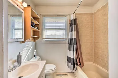 a bathroom with a sink and a toilet and a tub at House with Pellet Smoker and Grill, 1 Mi to Lake! in Bellmawr