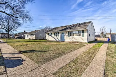 a white house with a gray roof on a yard at House with Pellet Smoker and Grill, 1 Mi to Lake! in Bellmawr