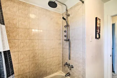 a bathroom with a shower with a tub at House with Pellet Smoker and Grill, 1 Mi to Lake! in Bellmawr