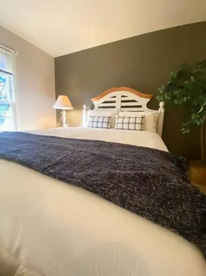 a bedroom with a large bed with white sheets and pillows at NEW Contemporary Chalet 5 Bed/3 Bath in Split Rock in Lake Harmony