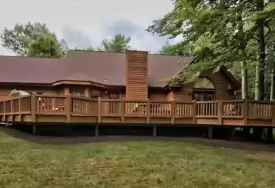 a home with a large deck with a house at NEW Contemporary Chalet 5 Bed/3 Bath in Split Rock in Lake Harmony